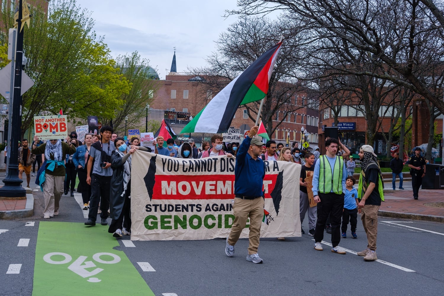 Protesters march through Harvard Square to the Harvard Kennedy School on Saturday.
