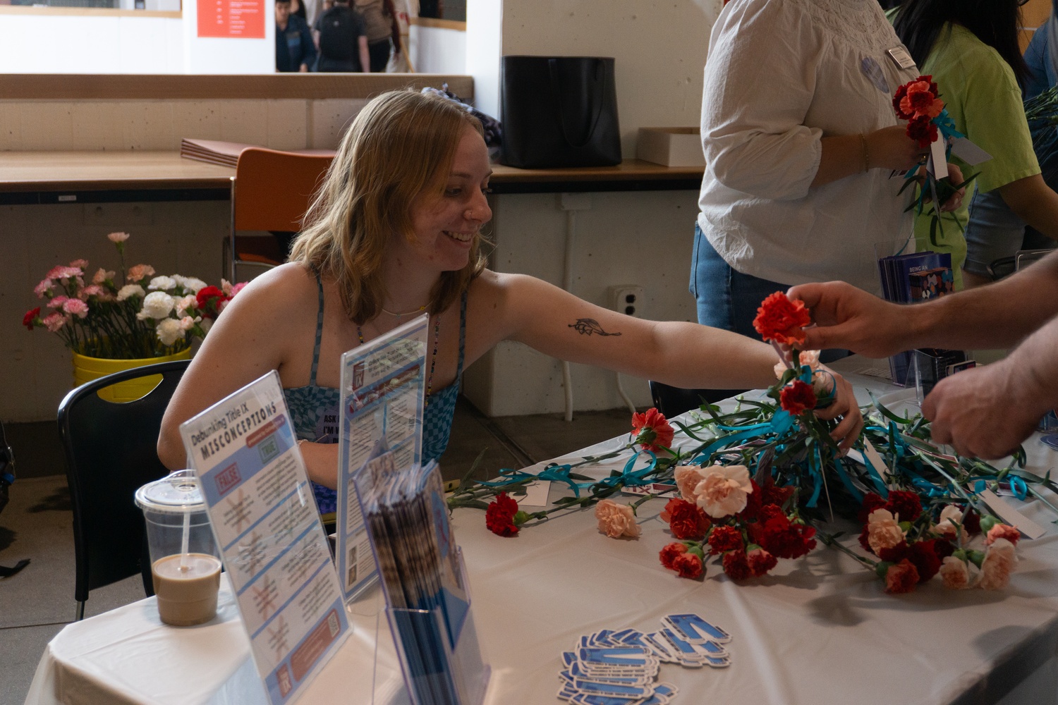 Volunteers hand out flowers for Denim Day on Wednesday.