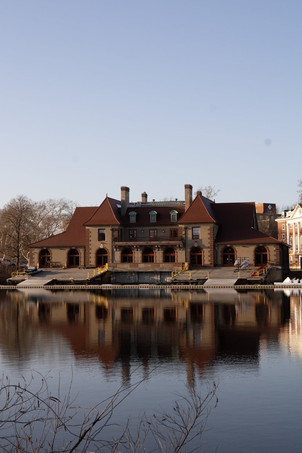 Weld Boat House reflected in the Charles River in the winter.
