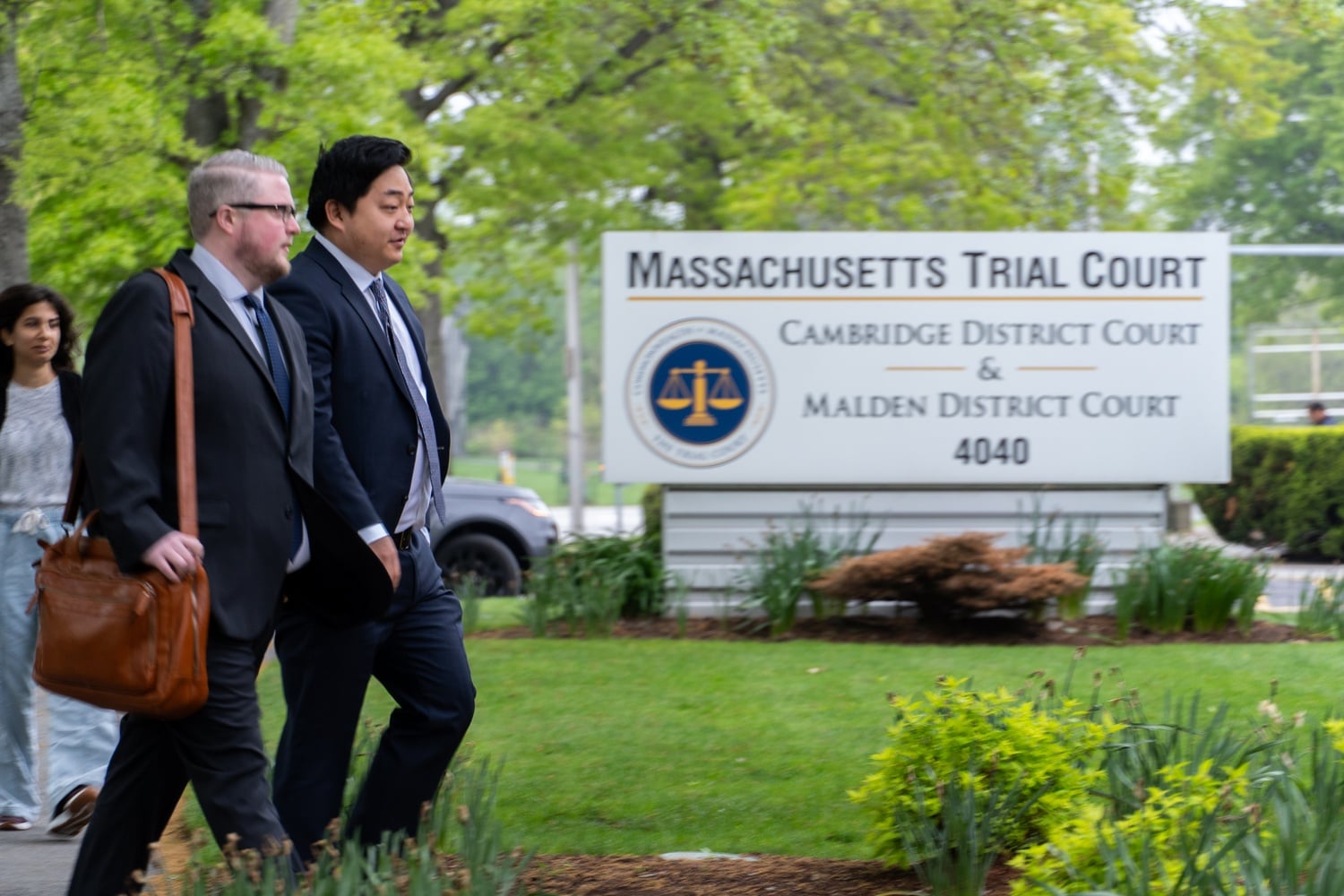 Mark Zhu (right) and his attorney walk into Cambridge District Court on Friday morning for the first round of arraignment hearings for men accused of patronizing a brothel network in Cambridge.