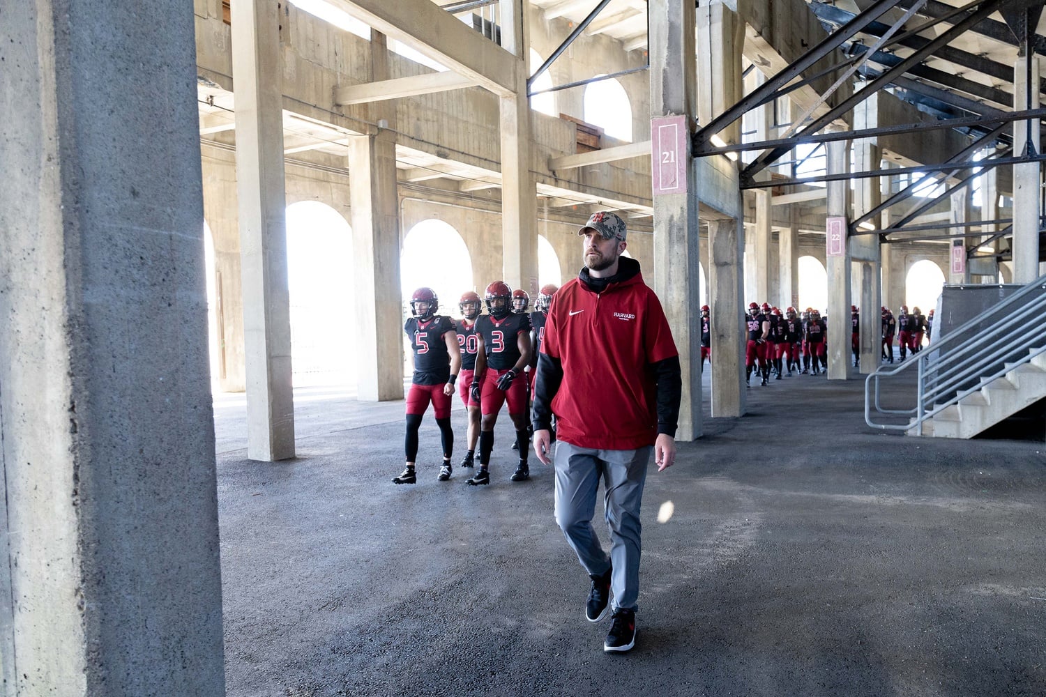 Head Coach Andrew Aurich leads his team onto the field at Harvard Stadium. With a season under his belt, he hopes to build his legacy one game at a time.