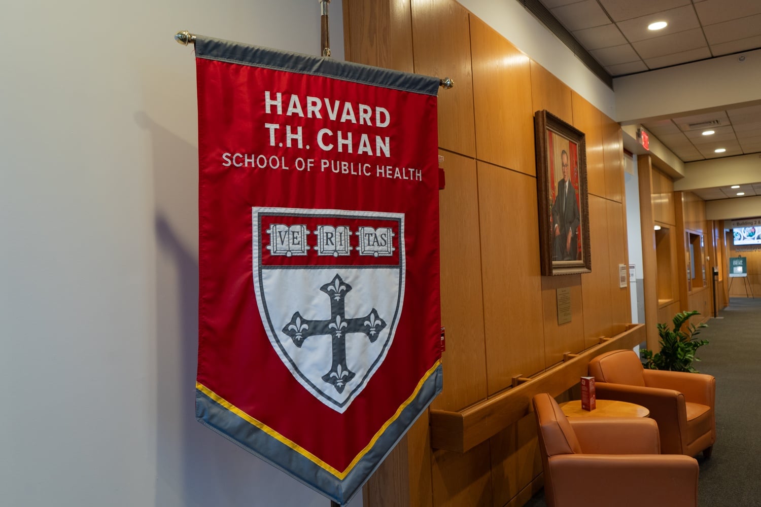 A banner hangs at the Harvard T.H. Chan School of Public Health in May 2025. HSPH has privately weighed seeking research funding from UnitedHealthcare, Tenet, and CVS Aetna as it looks to replace money lost to federal funding cuts.