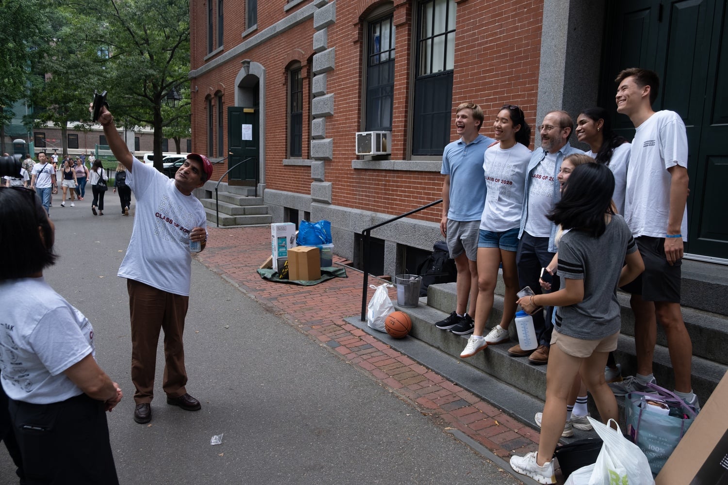 Harvard College Dean Rakesh Khurana snaps a selfie with students and University President Alan M. Garber ’76 during fall 2024 freshman move-in.