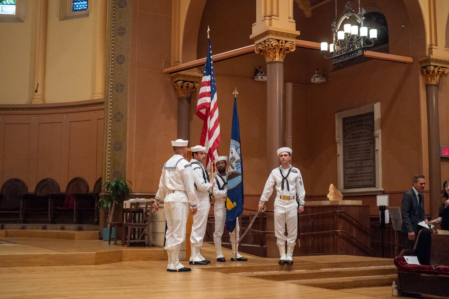 Harvard veterans assemble onstage for a graduation affinity celebration in Cambridge. Student veterans at the Kennedy School criticized a Defense Department directive ending graduate partnerships with the University.
