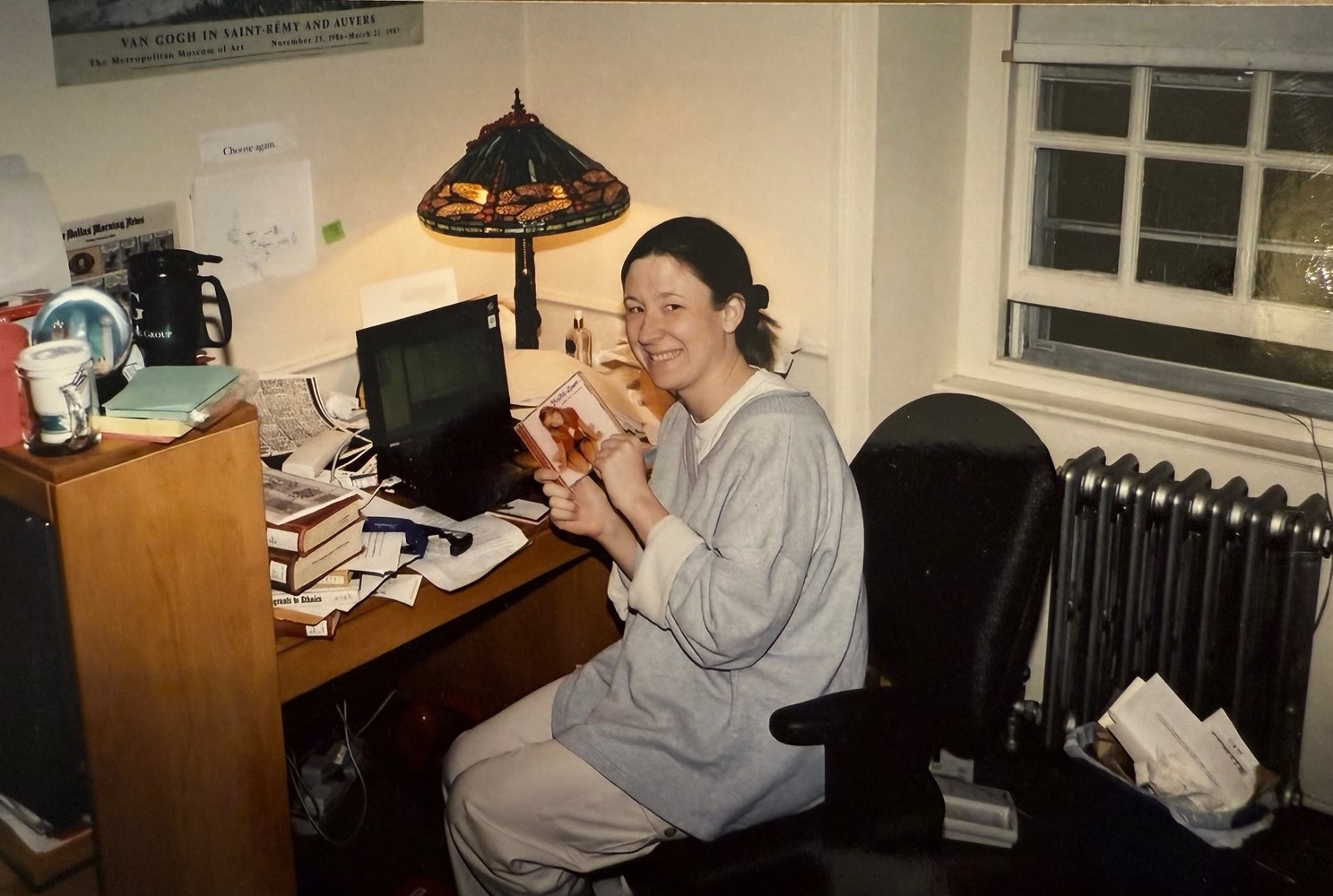 Lauren Jobe ’00 holds up a CD at her desk in 2000 — just as Napster shook up how Harvard students discovered and shared songs.