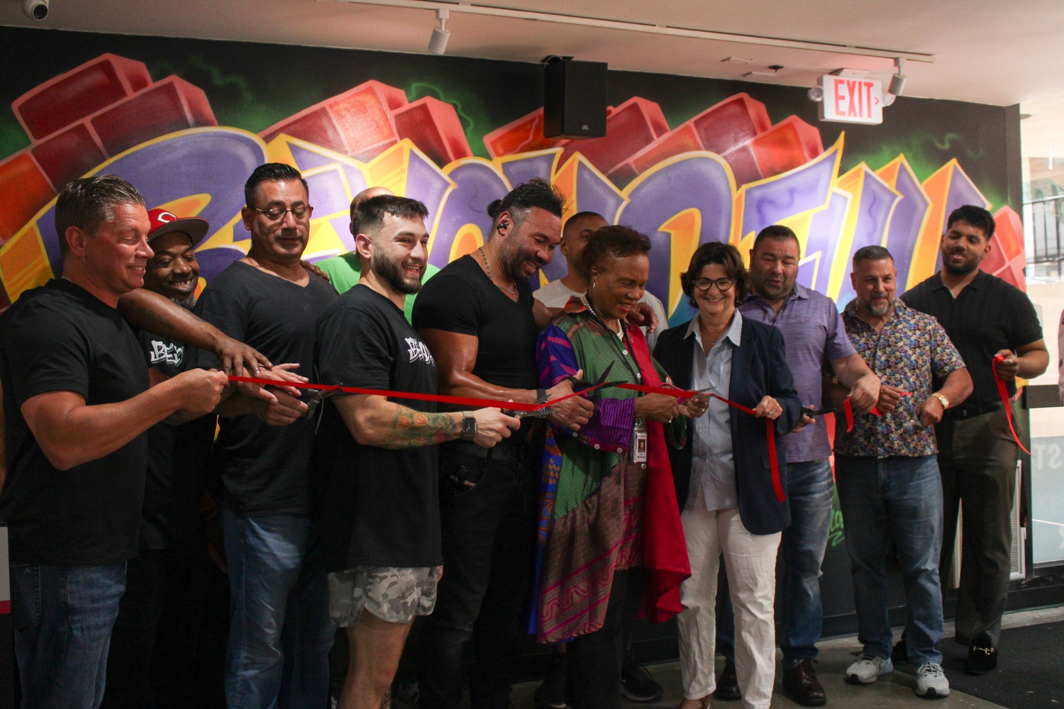 Staff at Beyond Full stand beside Mayor E. Denise Simmons and Harvard Square Business Association President Denise A. Jillson for the restaurant's ribbon cutting ceremony.