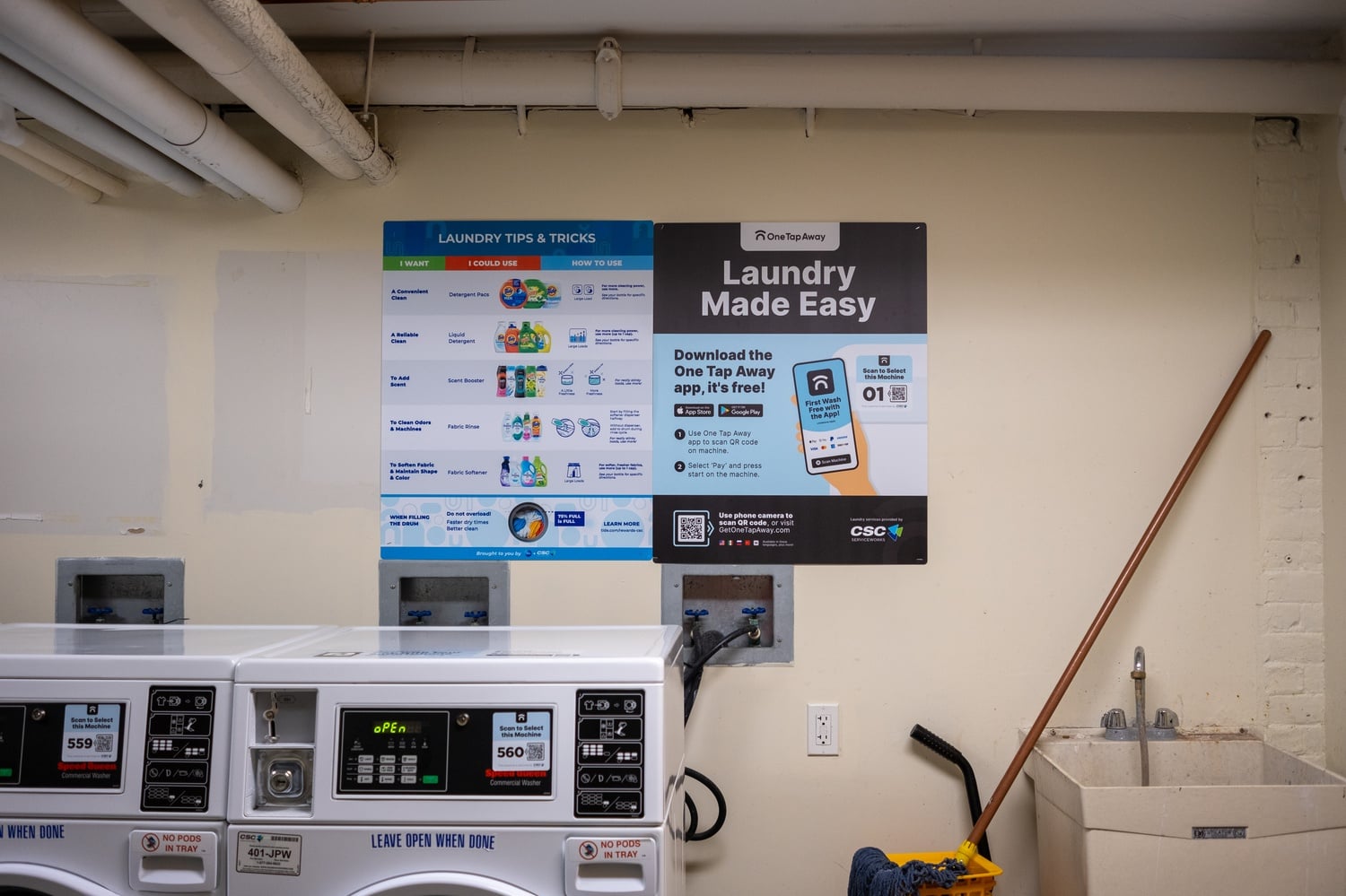 Posters in the laundry room of Fairfax Hall displaying the new payment system.