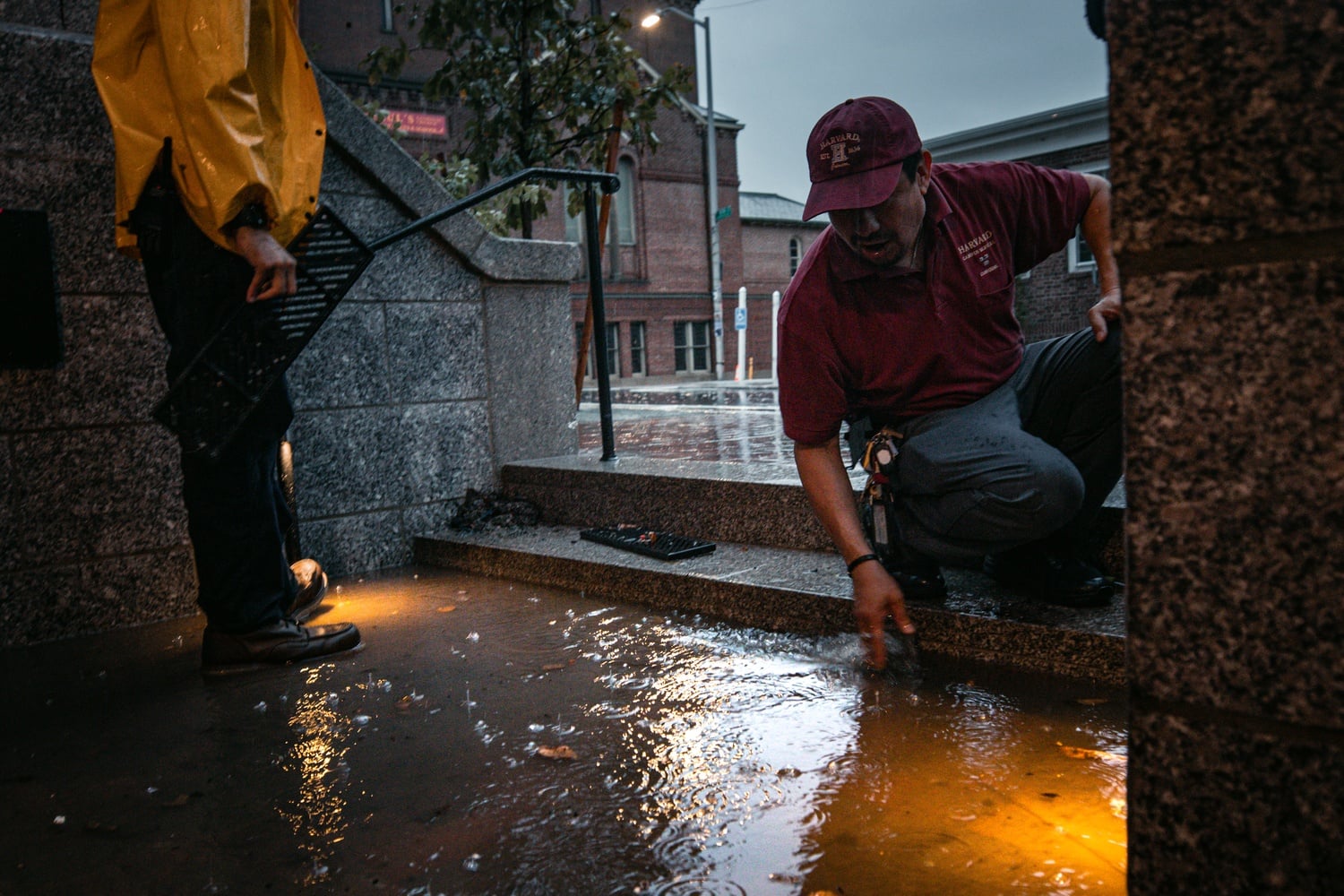 A Harvard staff member assesses the flooding in Adams House.