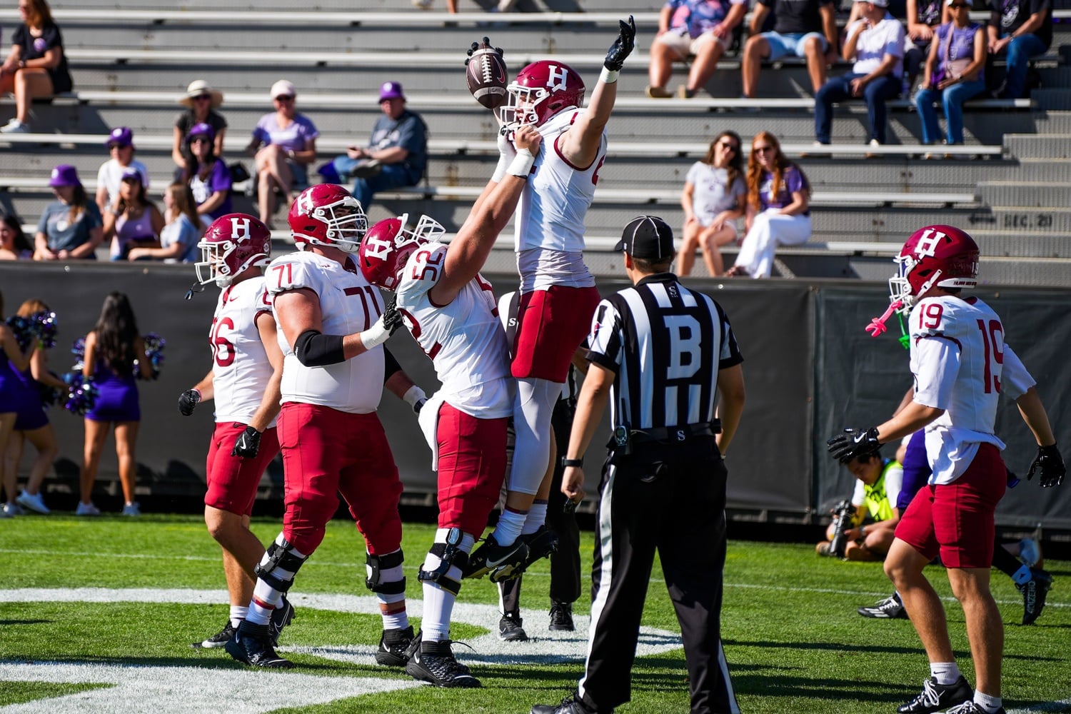 Junior tight end Logan Reaska is lifted by his teammates after he scored a touchdown in the game against Holy Cross Saturday.