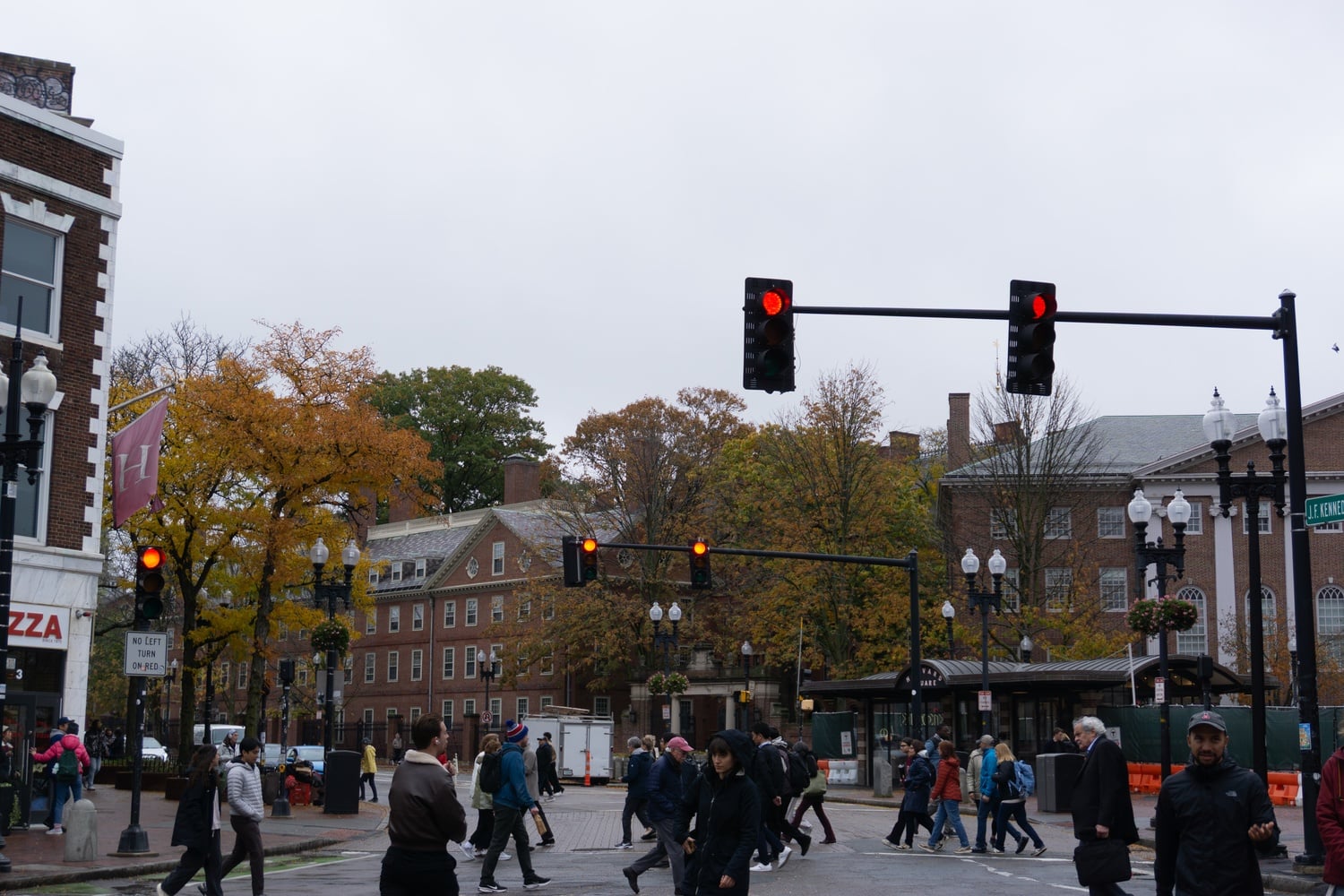 Pedestrians cross the street on Mass. Ave. in Harvard Square.