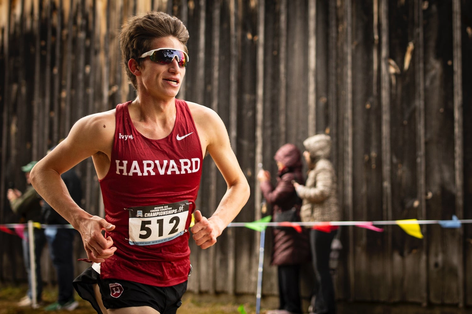 Sam Burgess races towards the finish line. The junior secured a third-place finish at the Northeast Regional Championships, helping the men's cross country team qualify for the NCAA Championships