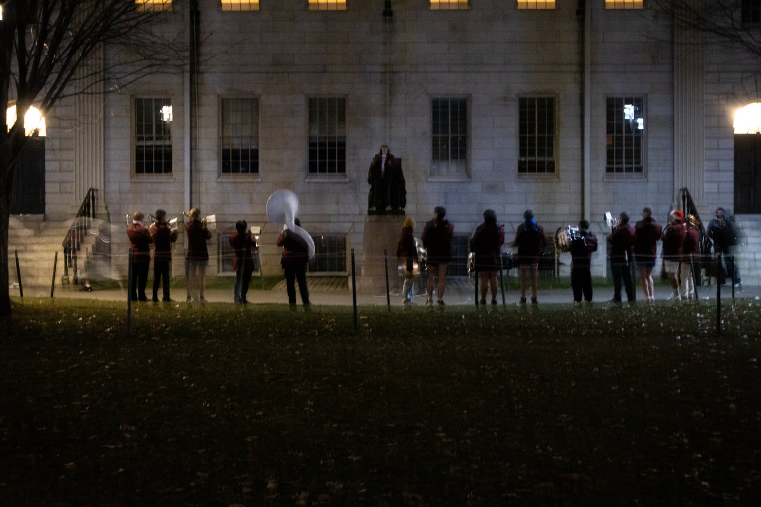 The Harvard University Band gathered in front of the John Harvard Statue to serenade primal scream runners just before midnight on Tuesday. The naked run is a semesterly tradition.