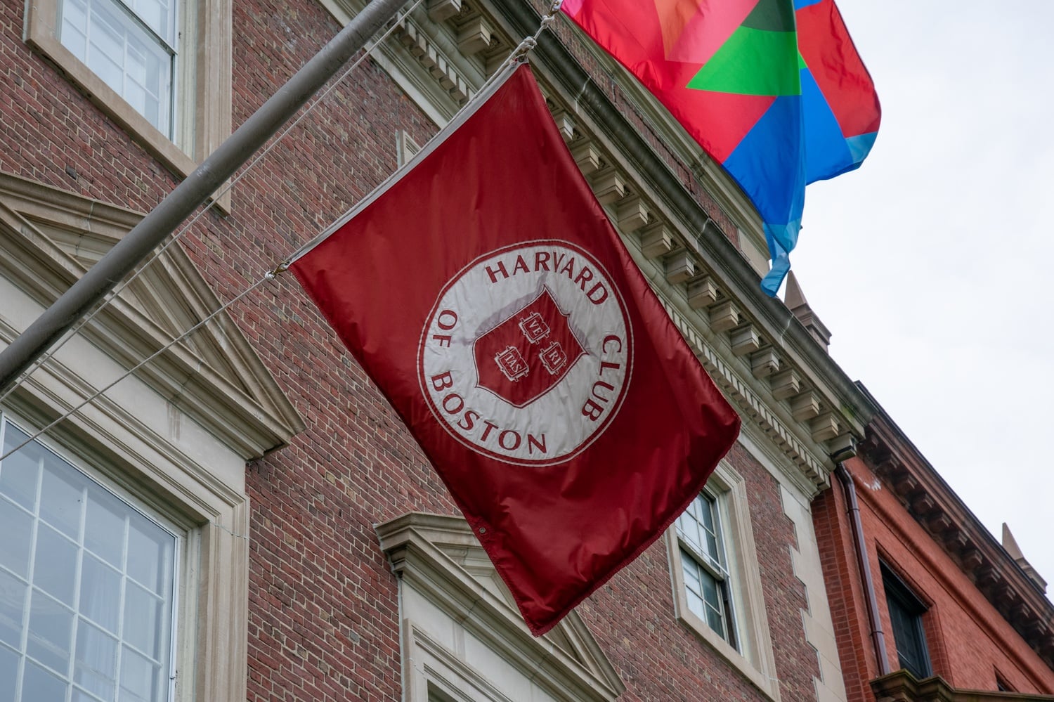 The Harvard Club of Boston will pay $2.4 million to settle claims it improperly received a pandemic-era loan.
