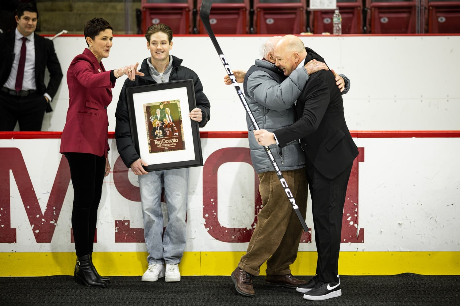 Ted Donato '91 hugs Bill Cleary, his former coach. Cleary led Donato and the Harvard team to win the national championship in 1989. Donato recently surpassed Cleary as the most winningest coach in Harvard hockey history. 
