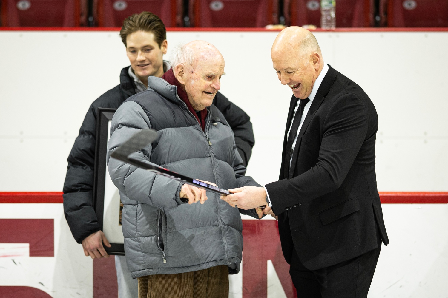 Ted Donato '91 laughs with his former coach, Bill Cleary, on the ice in the Bright-Landry Hockey Center.