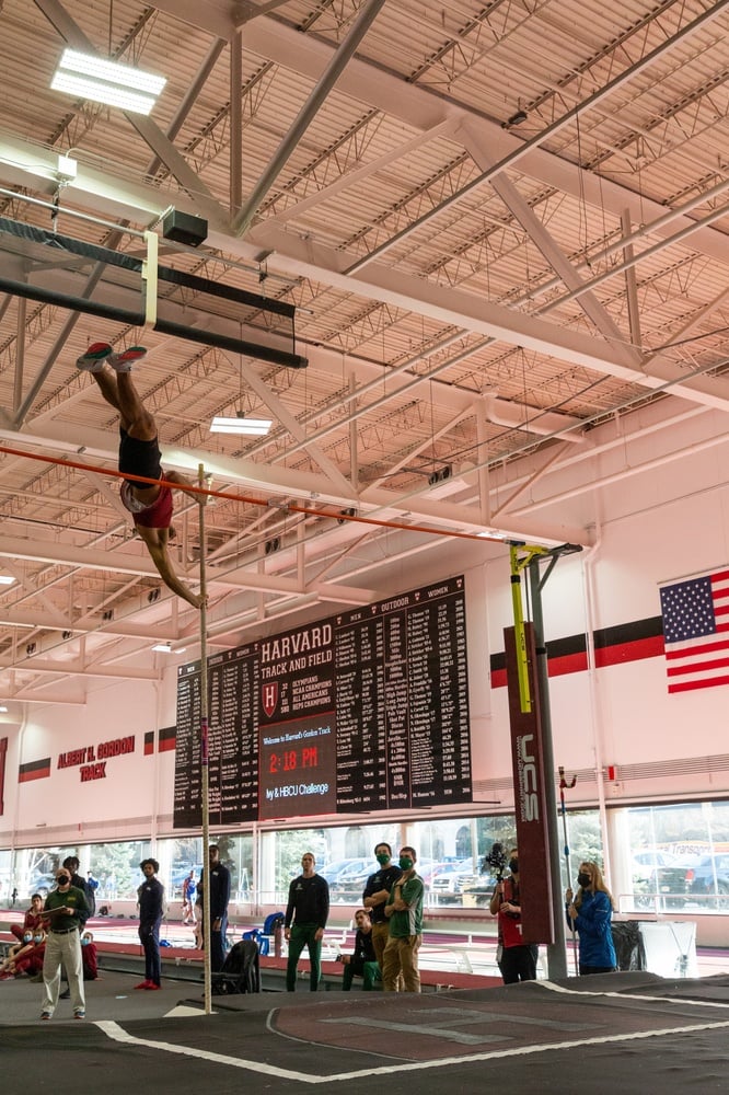 A Harvard pole vaulter competes at the indoor track and field meet on Saturday, Dec. 4, 2021. This year, sophomore Ella McRitchie and junior Lilly Hodge both placed in the top three of the women’s pole vault.