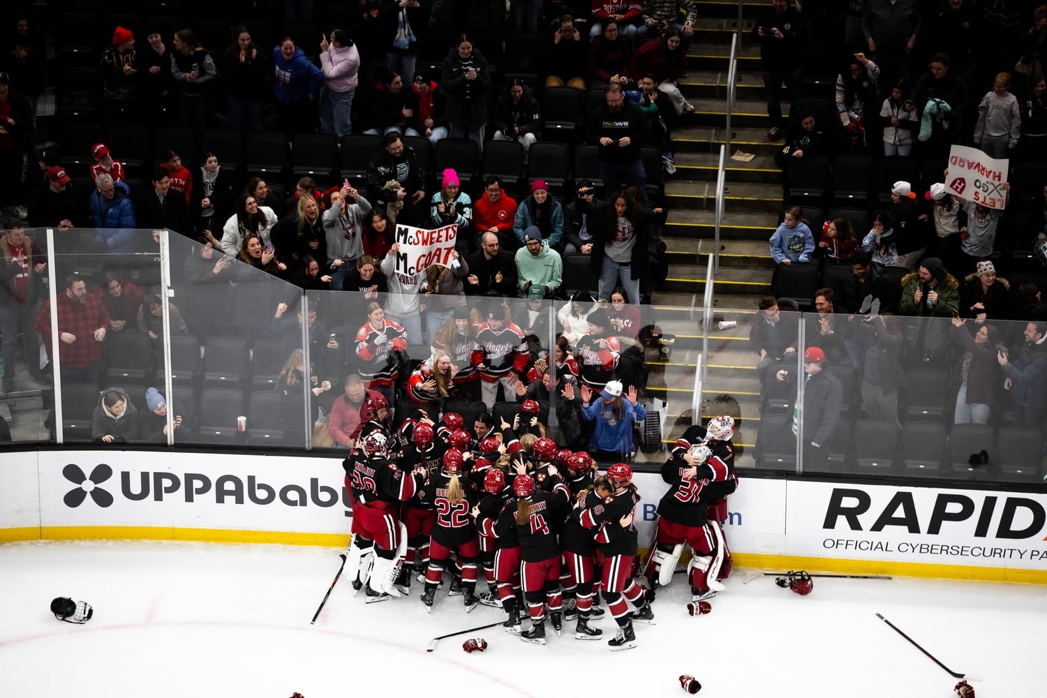 The Crimson celebrates its win with its fans at TD Garden
