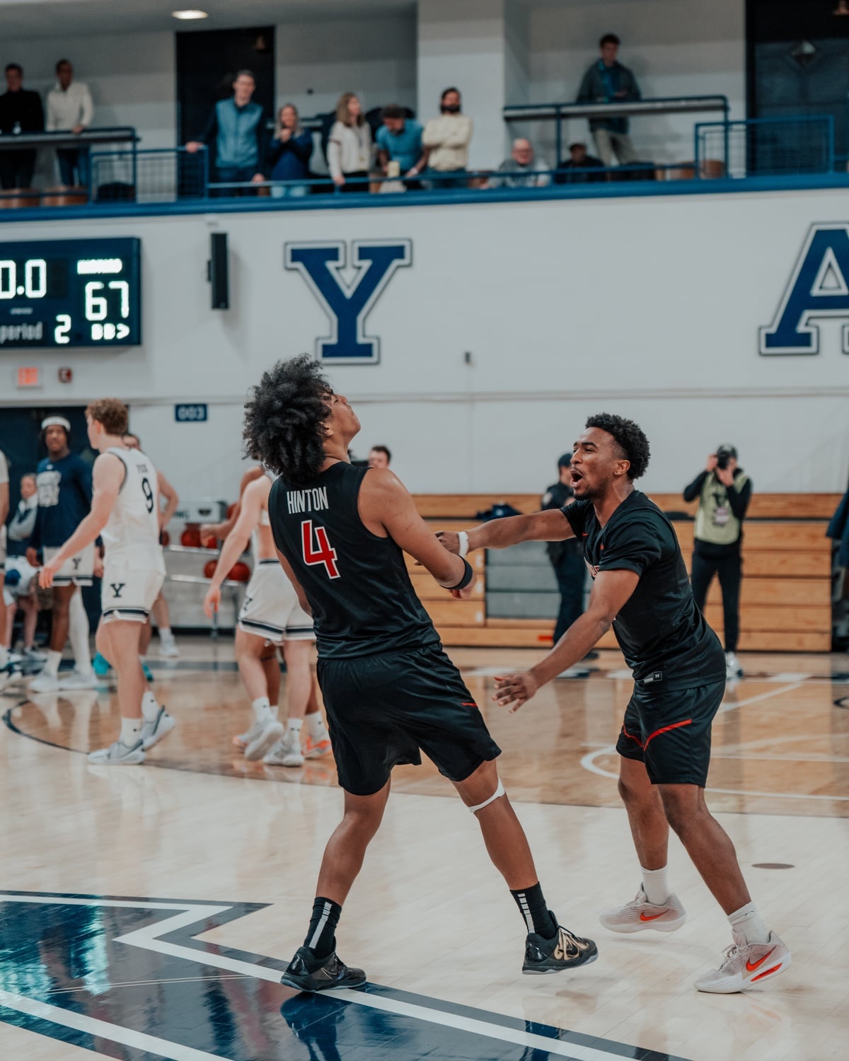 Sophomore guard Robert Hinton and junior guard Xavier Nesbitt rejoice on the court. 