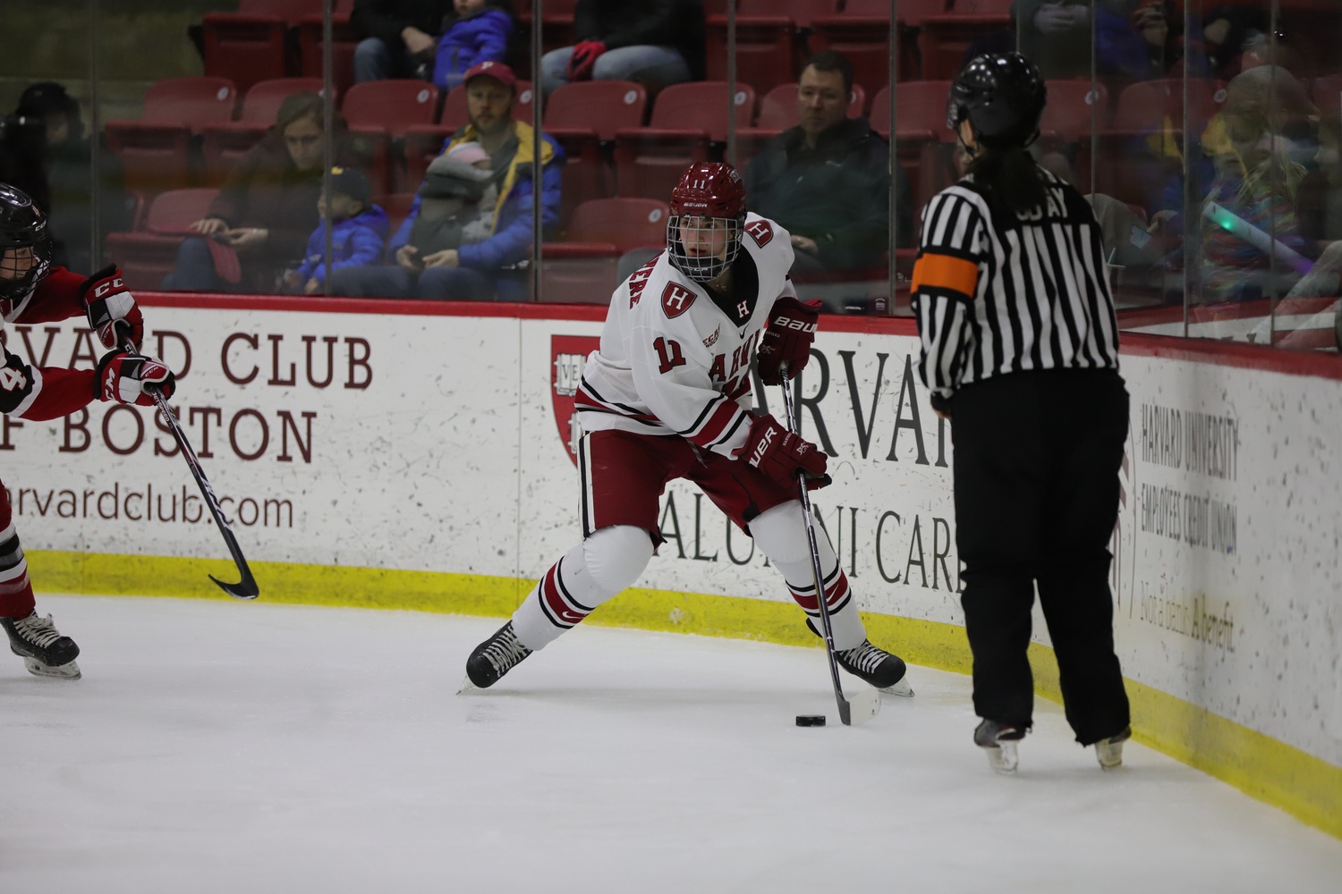 Kristin Della Rovere '23 dangles along the boards during a game against St. Lawrence in 2020.