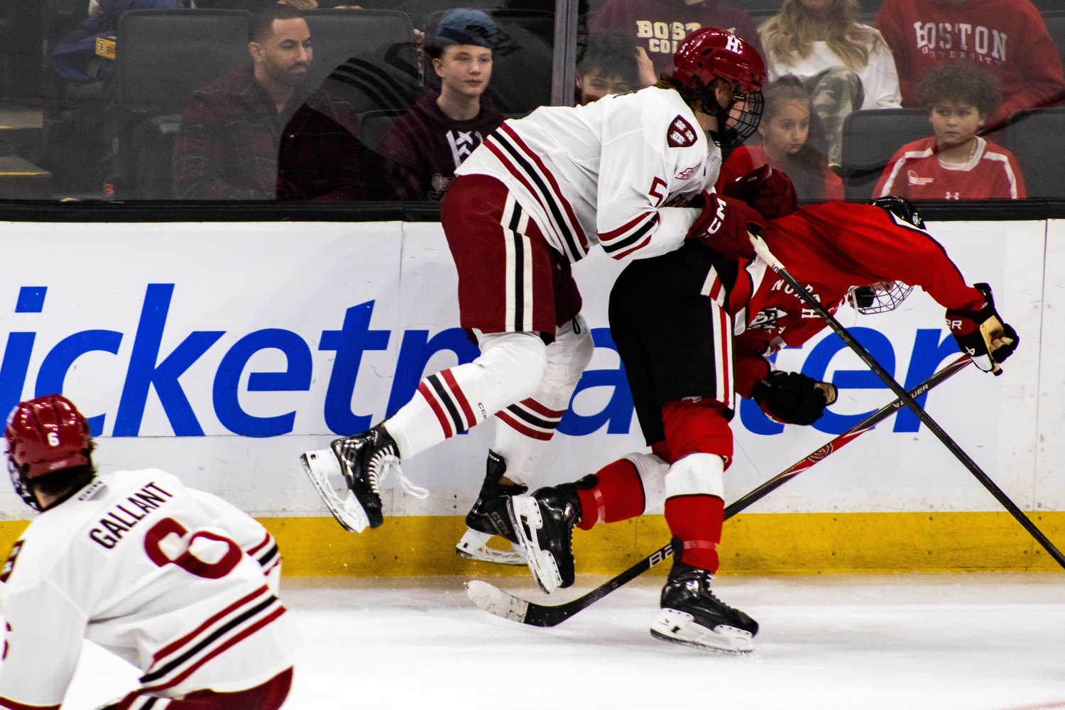 A hard check by senior Sean Keohane displays the physical play that defined the game for Harvard