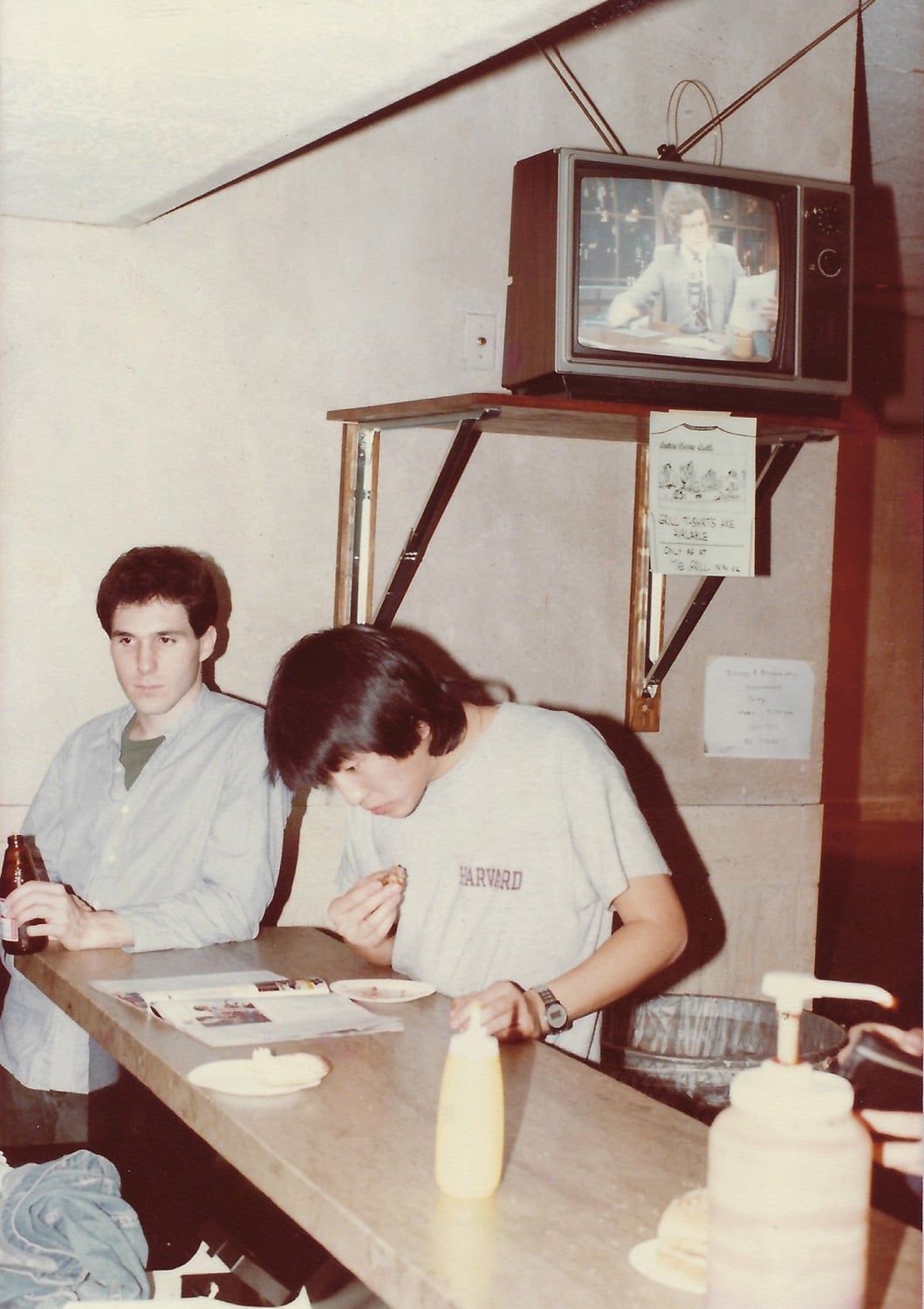 Roger V. B. Gould ’84 (left) and Jang-Ho J. Cha ’83 (right) stand at the counter of the Quincy Grill.