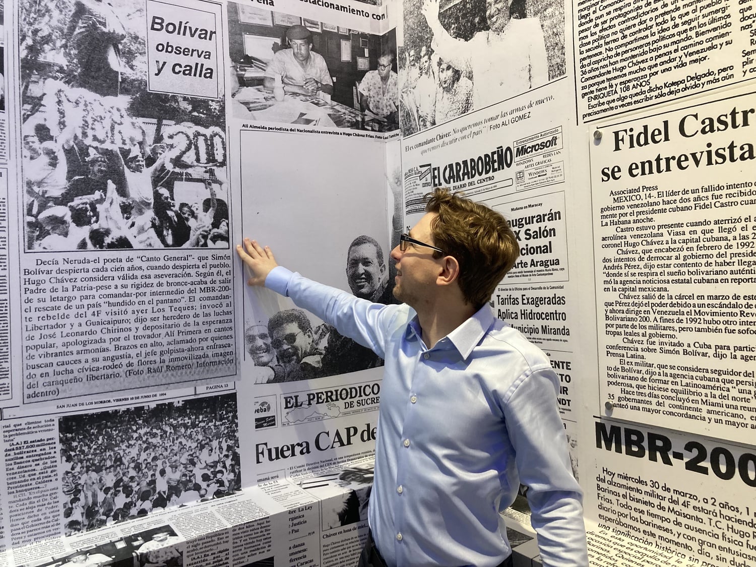 Lucas M. Koerner with an exhibit of his archival work on the newspaper coverage of Hugo Chávez's 1994 tour of the country.