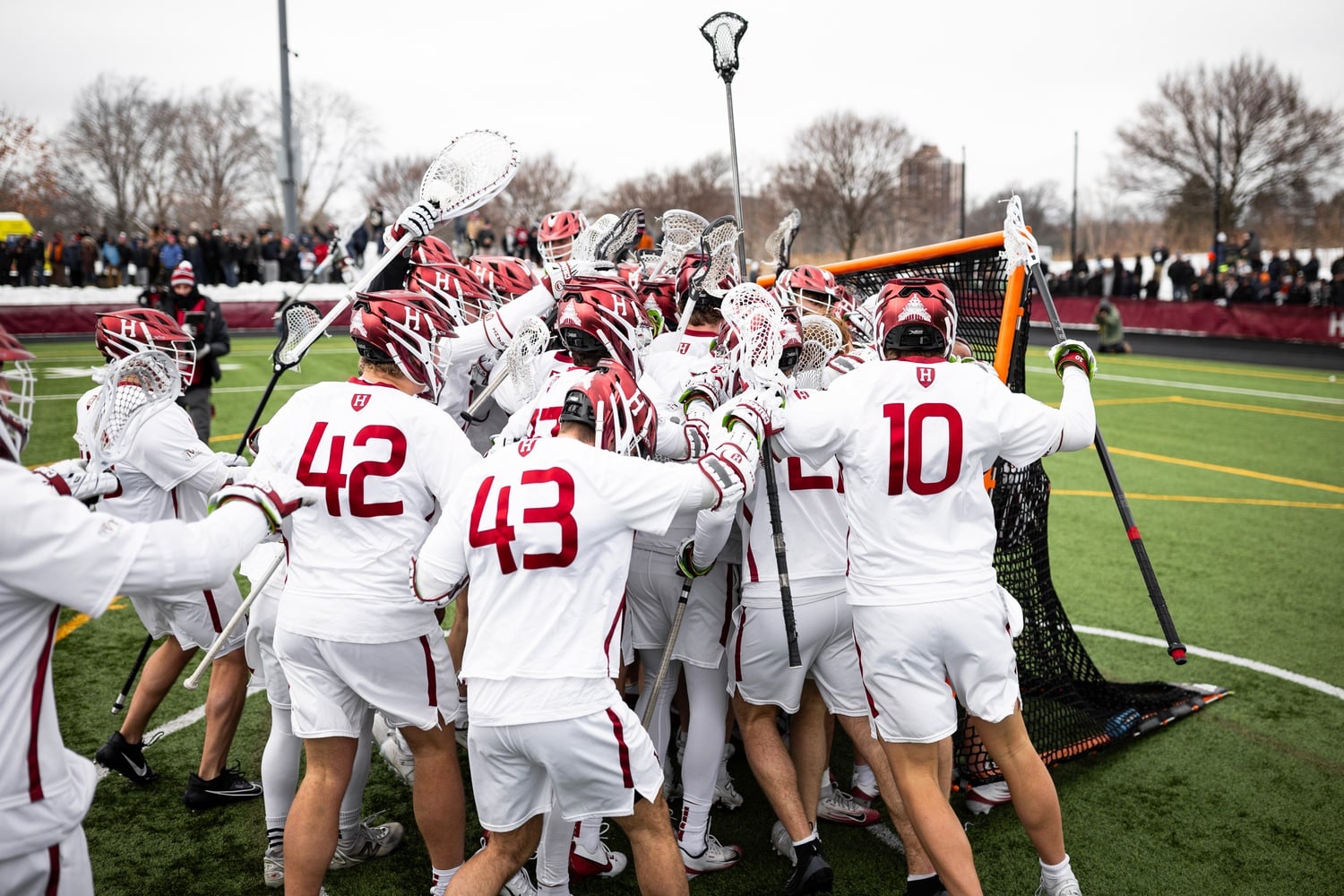 The men's lacrosse team swarms sophomore goaltender Graham Stevens after upsetting No. 1 Syracuse.