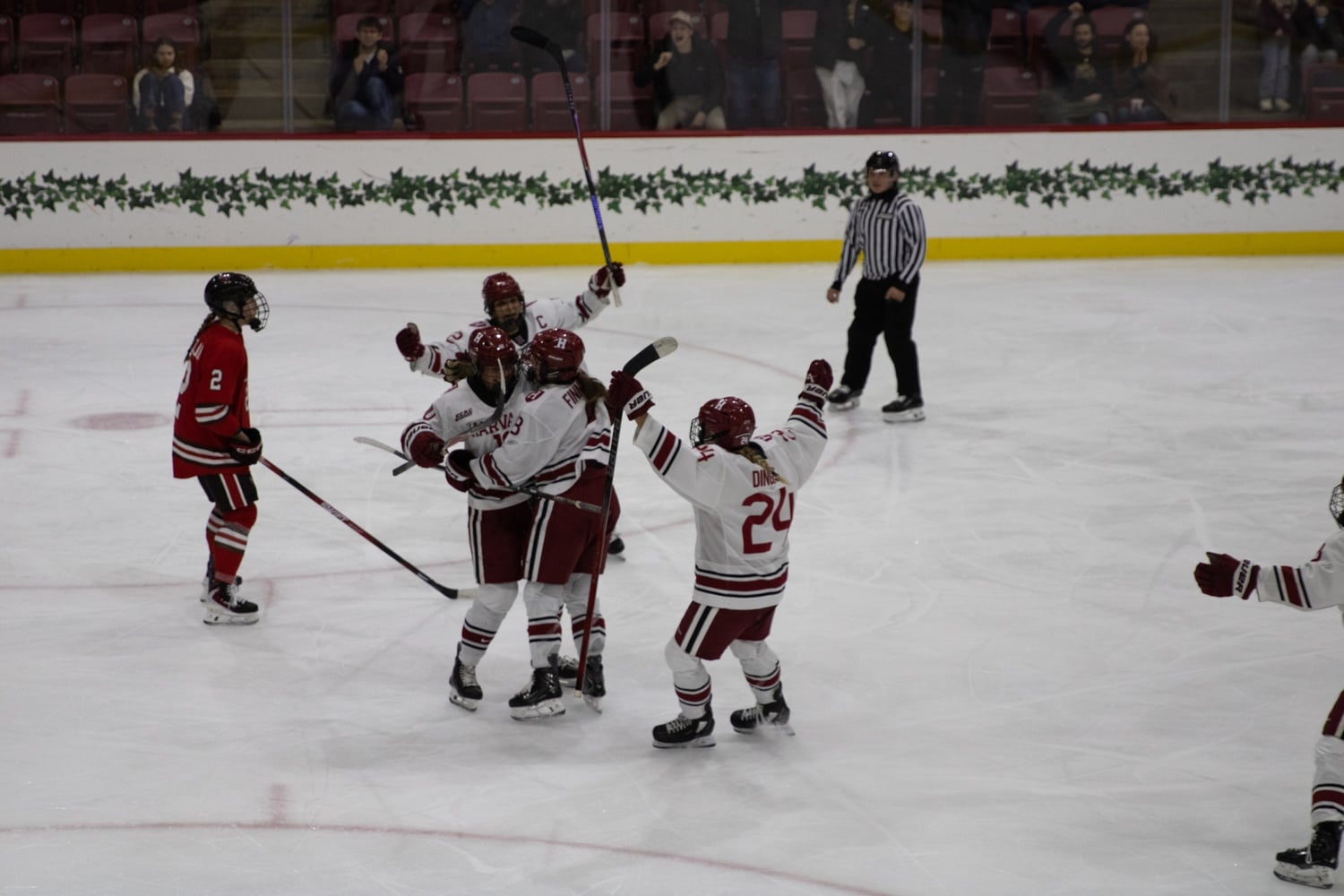 The women's ice hockey team celebrates a goal against St. Lawrence in the opening round of the ECAC Tournament. Today, the Crimson beat Princeton 3-1.