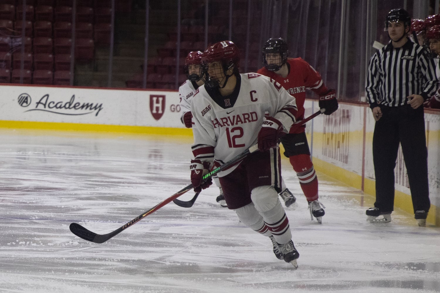 Junior captain Zoe Boosamra skates down the ice for the Crimson