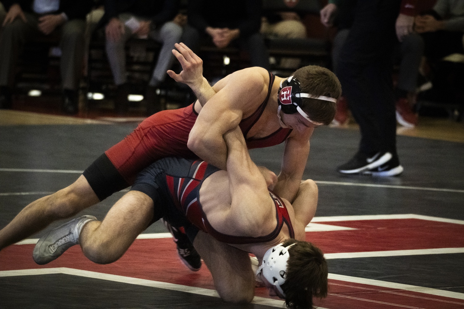 A Harvard wrestler faces off against a Penn wrestler earlier this season.