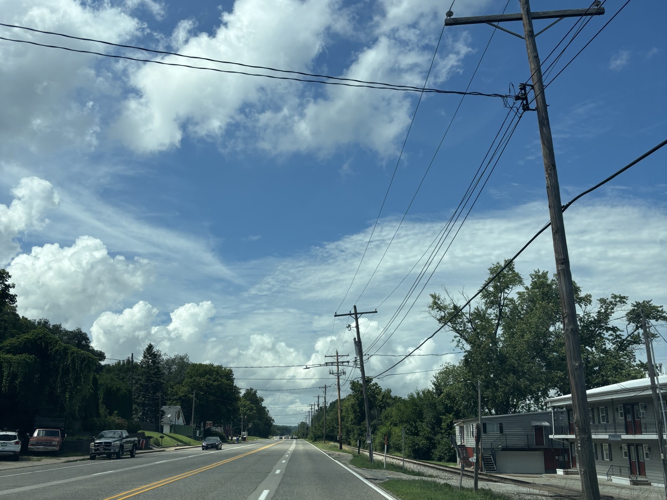 A picture from the wheel of a car. The road follows the Illinois River and winds back to the author’s house.