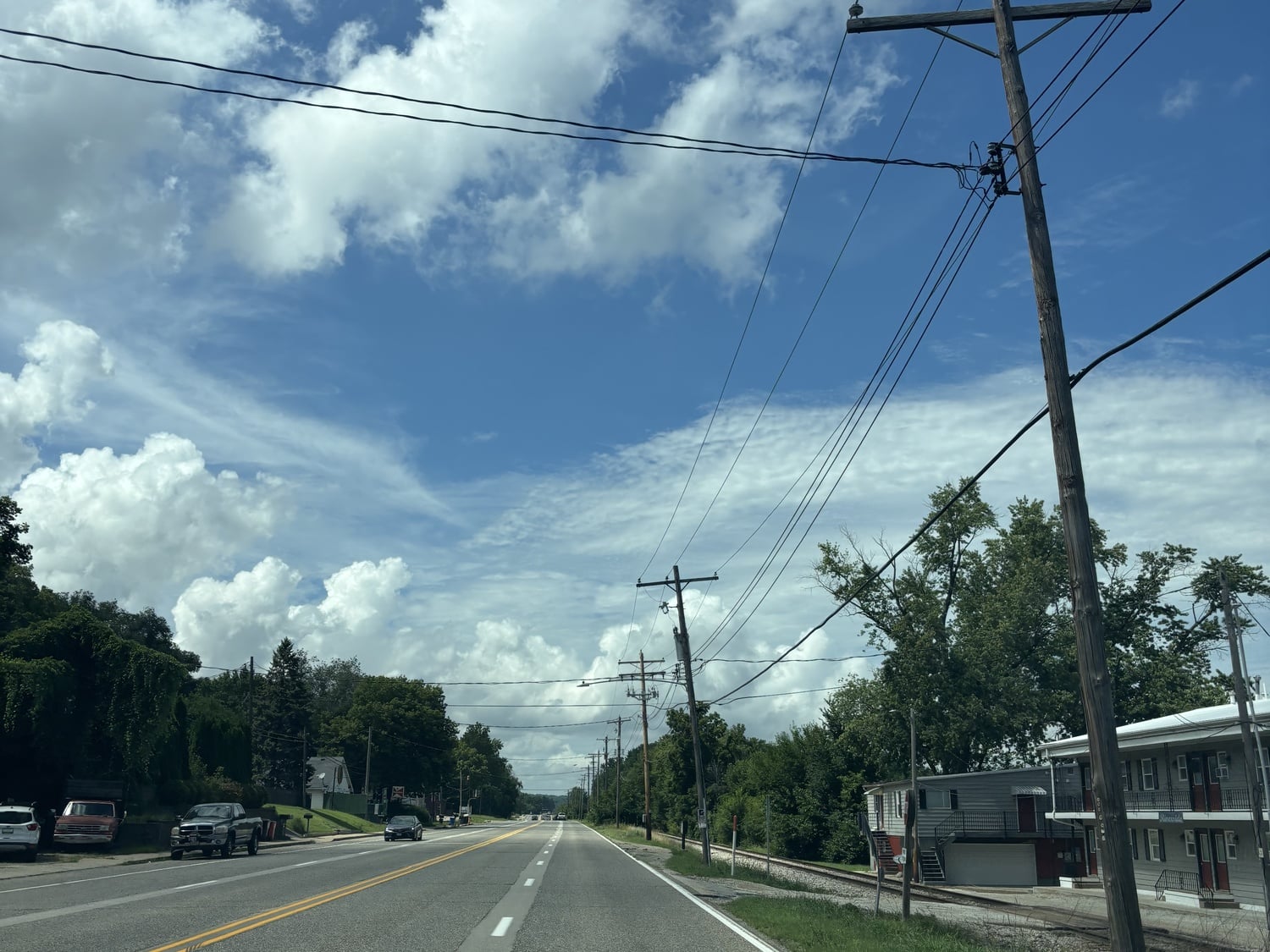 A picture from the wheel of a car. The road follows the Illinois River and winds back to the author’s house.