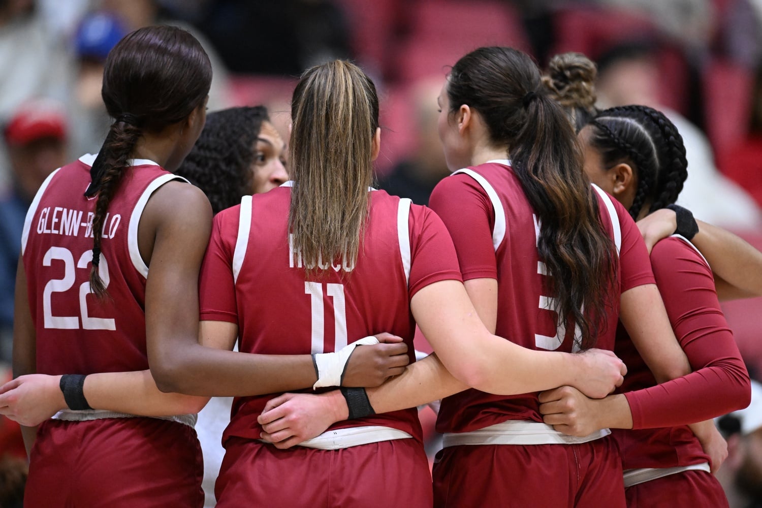 Harvard's starters huddle to listen to their head coach Carrie Moore.