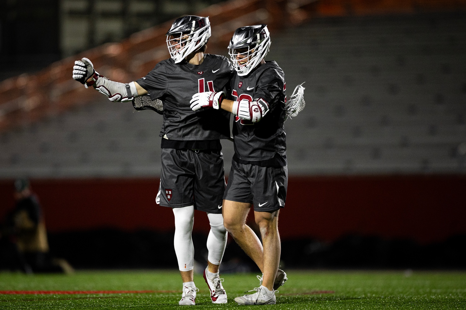Juniors Jack Speidell and Jack Peterson celebrate a goal. Speidell notched his 100th collegiate goal during the Crimson's win over Boston University.