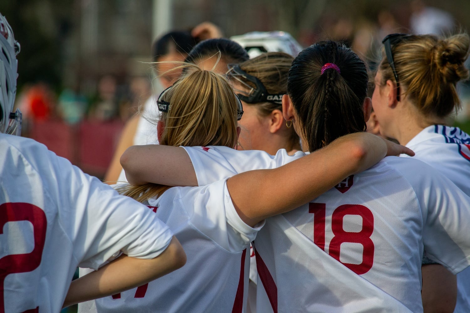The Harvard women's lacrosse team huddles during a game against Yale last season.