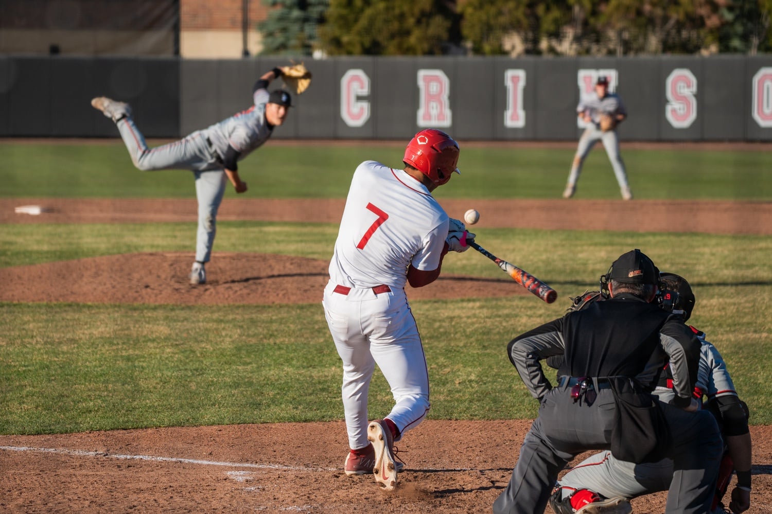 Harvard captain Gio Colasante attacks a pitch at the plate.