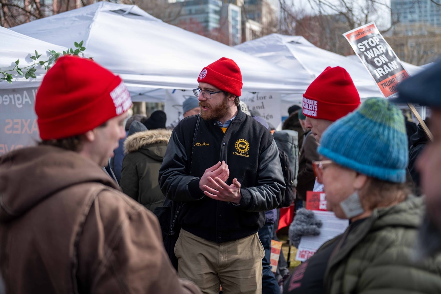 Evan MacKay in a lively discussion with fellow Boston DSA members at a No Kings protest in late March.