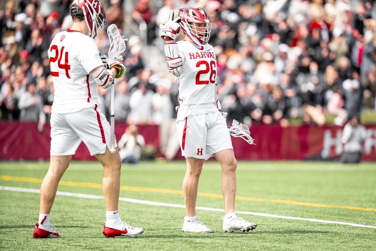 Senior attacker Teddy Malone and freshman midfielder Logan Turley take the field against Princeton.
