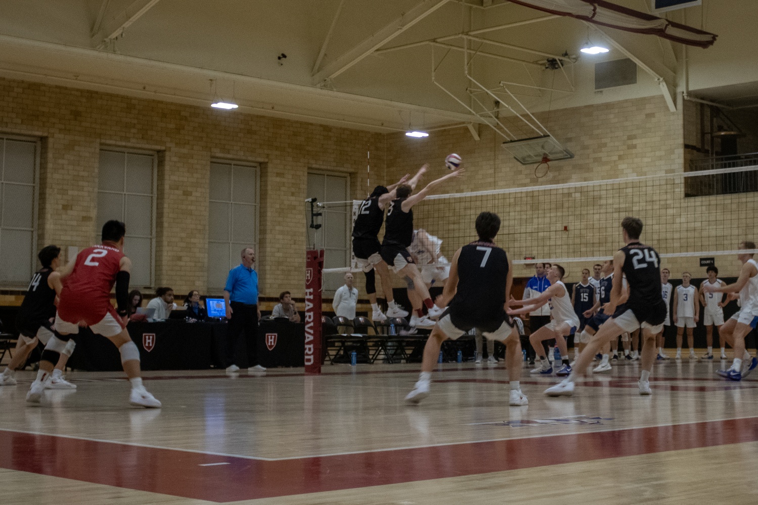 Co-captains Zach Berty and Brian Thomas rise up to set the block for Harvard against BYU.