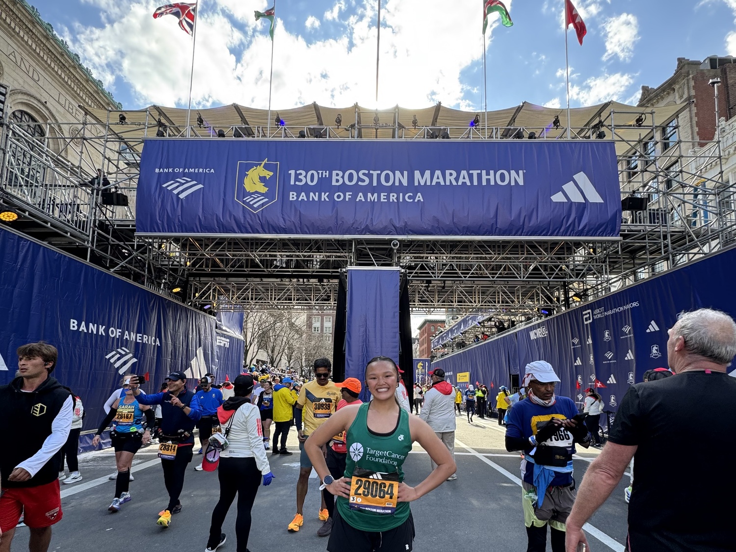 Hannah Nguyen celebrates finishing the Boston Marathon.