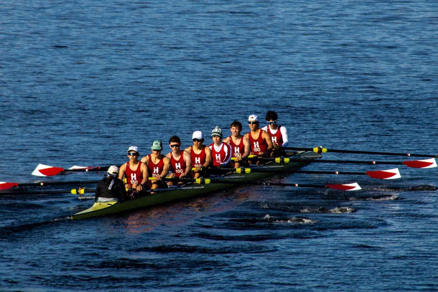 The Harvard men's light weight 3V boat competes on the Charles against Princeton and Yale.
