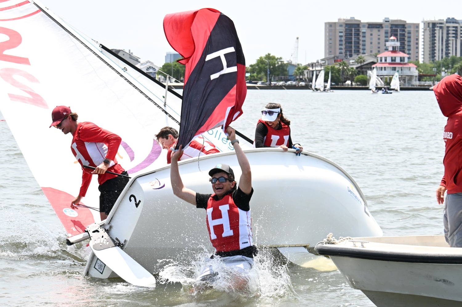 The Harvard sailing team jumps into Lake Pontchartrain after winning its second straight ICSA Open Team Racing National Championship. 