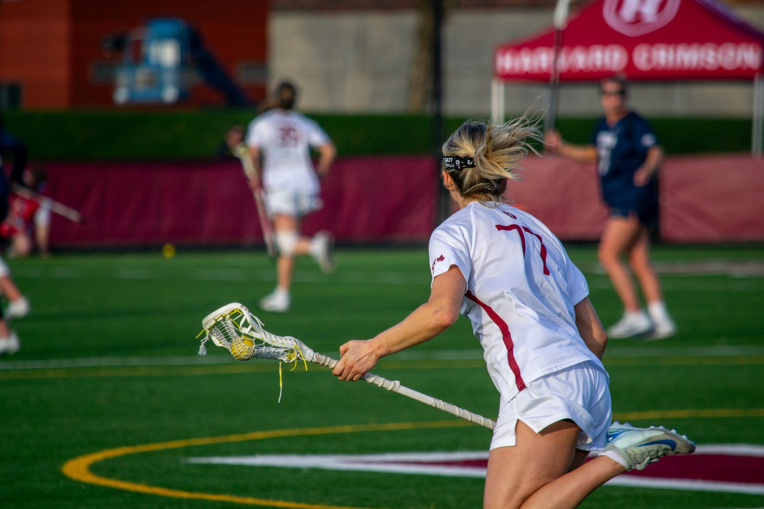 Harvard senior midfielder Charlotte Hodgson works her way down the field for the Crimson