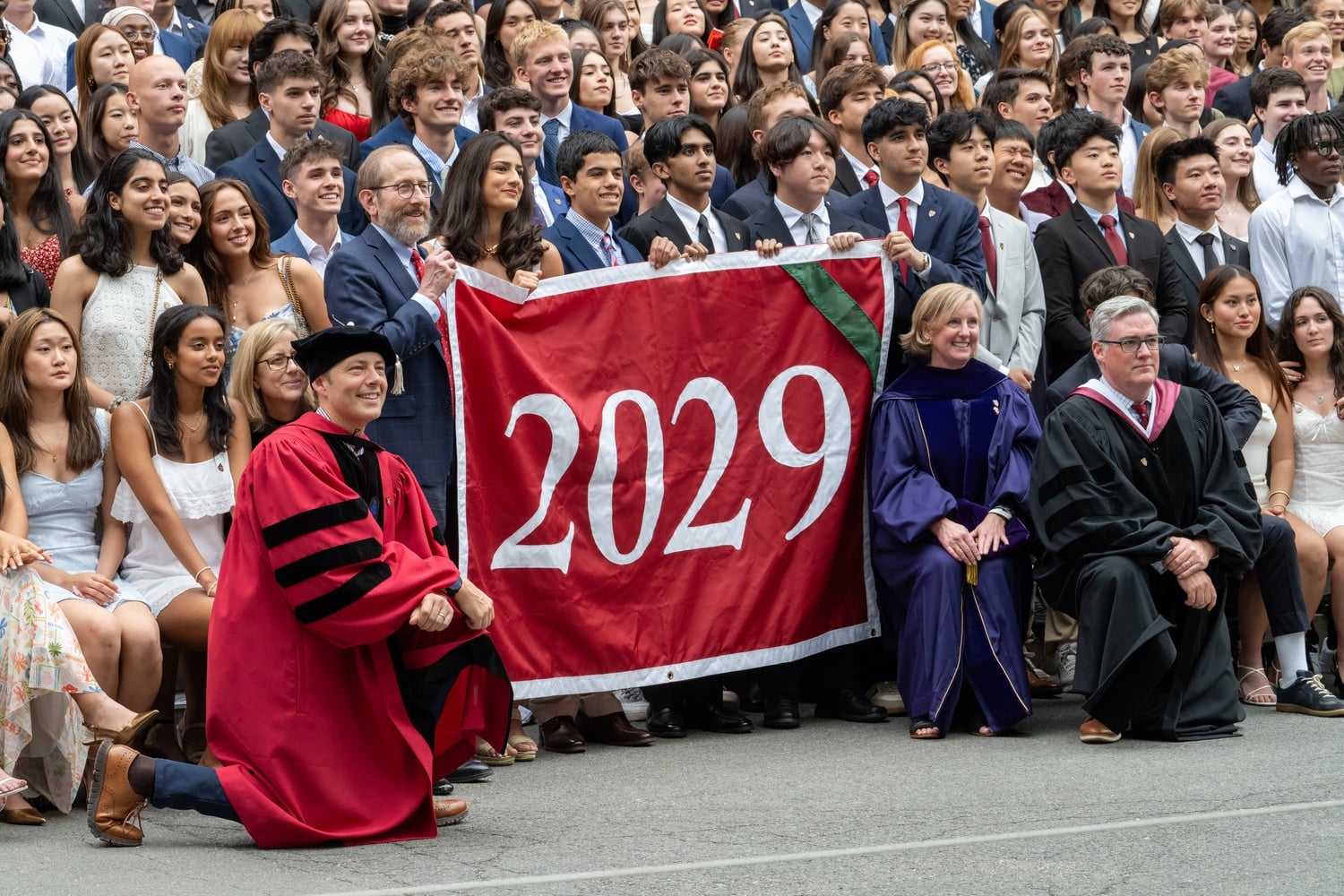 David J. Deming poses with students and other Harvard administrators at the Class of 2029 Convocation.