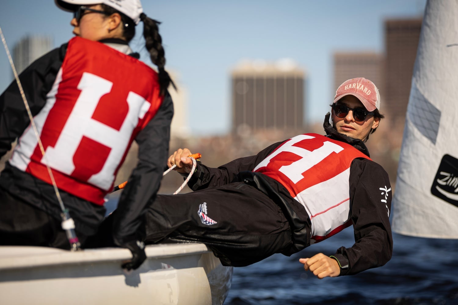 Justin Callahan leans out of the boat as he practices on the Charles River.