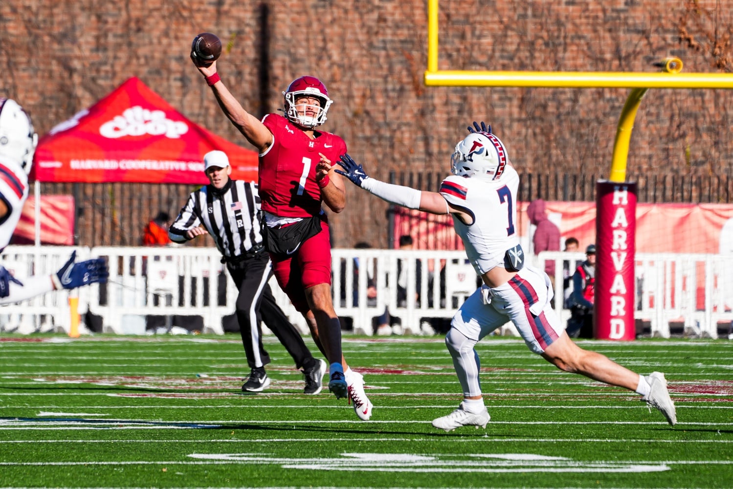 Harvard senior quarterback Jaden Craig makes a throw while on the run in another prolific performance against Penn.