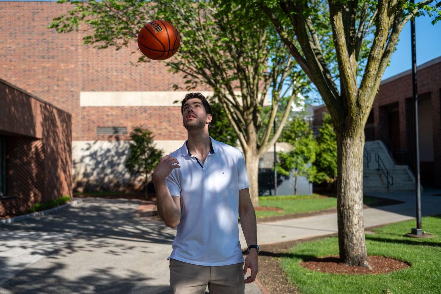 Harvard men's basketball freshman forward Avnor Dror poses with a basketball for The Crimson.