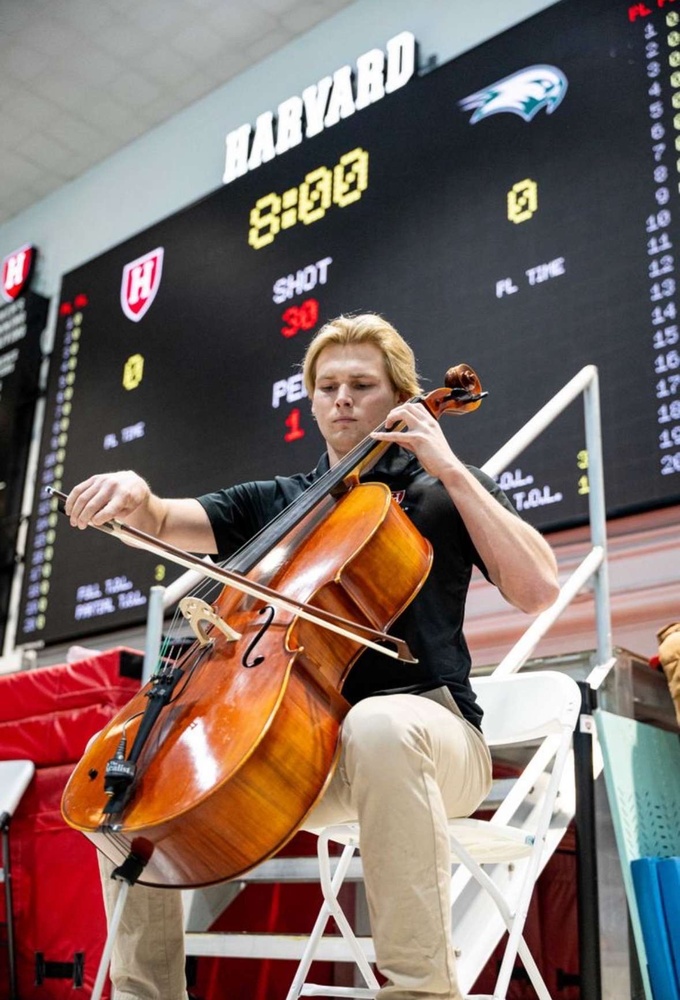 Men's water polo junior Bradford Dickson performs the National Anthem on his cello before competing in a game this season.