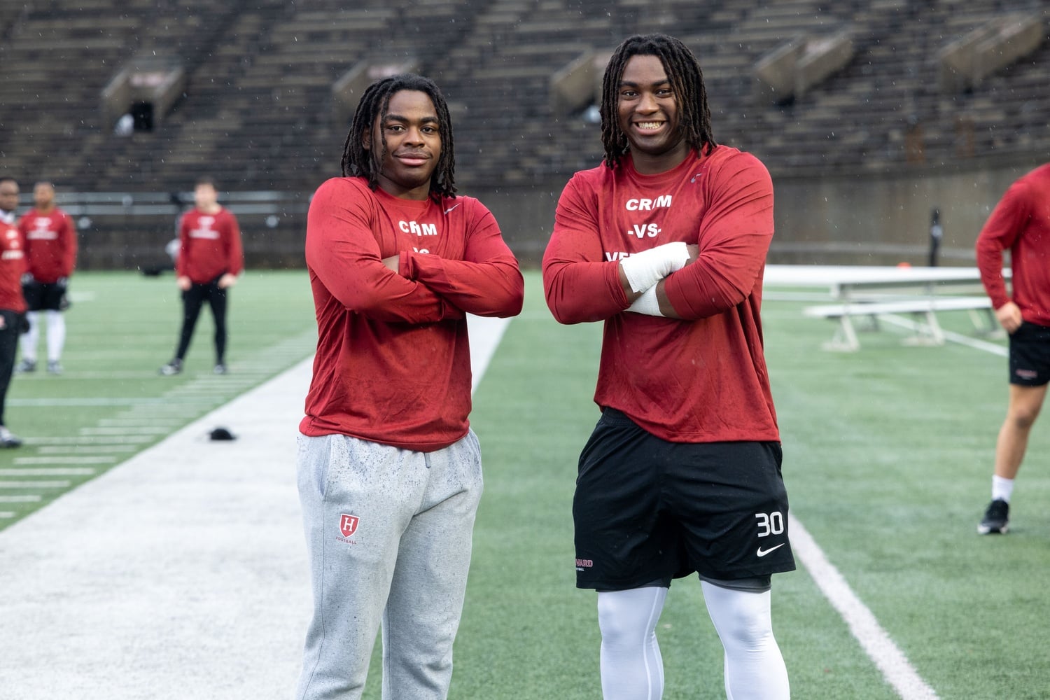 Juniors Kyle and Owen Johnson take the field at Harvard Stadium. 