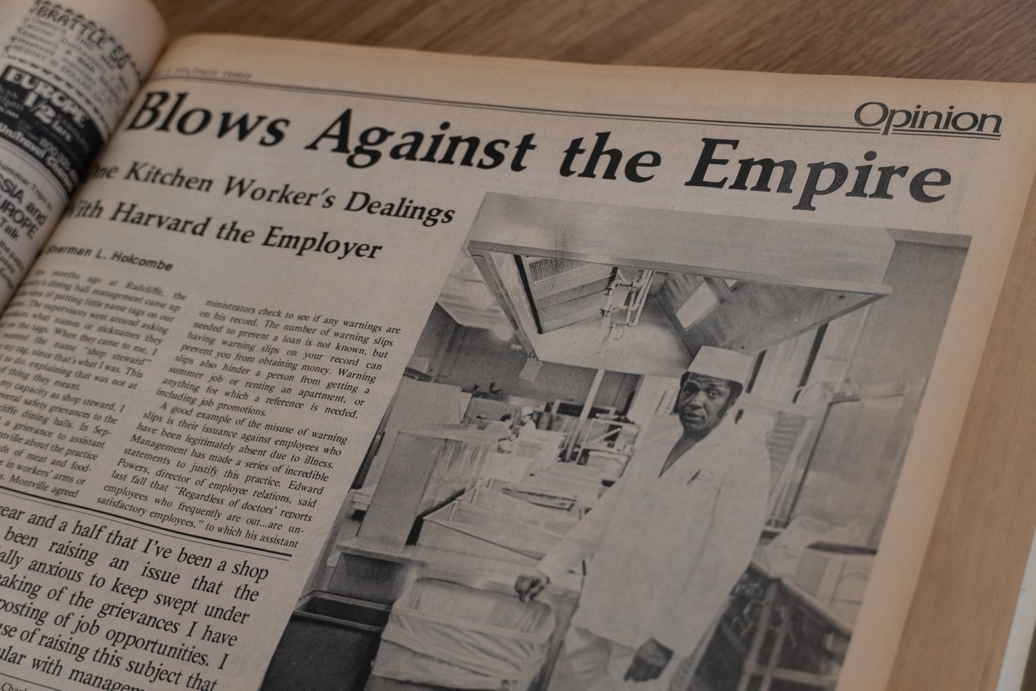 A 1976 print edition of The Crimson includes Sherman L. Holcombe's op-ed, 'Blows Against the Empire.' Holcombe's suspension galvanized members of the Class of 1976 around Harvard dining hall workers.